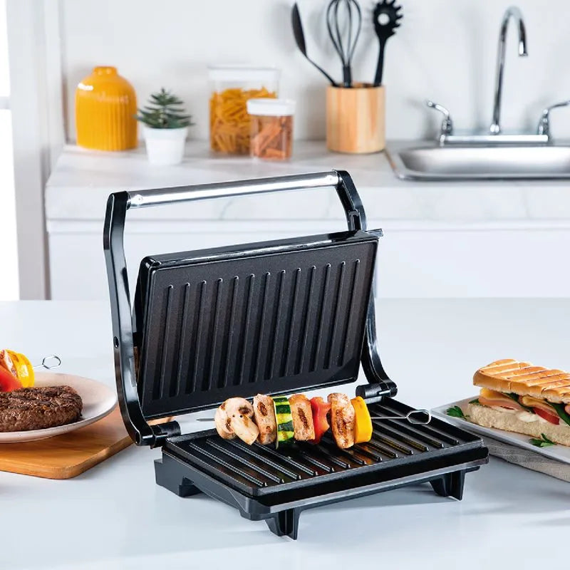 Sanduchera IMUSA Grill Basic Antiadherente con mango frío, cerradura lateral y placa superior ajustable.