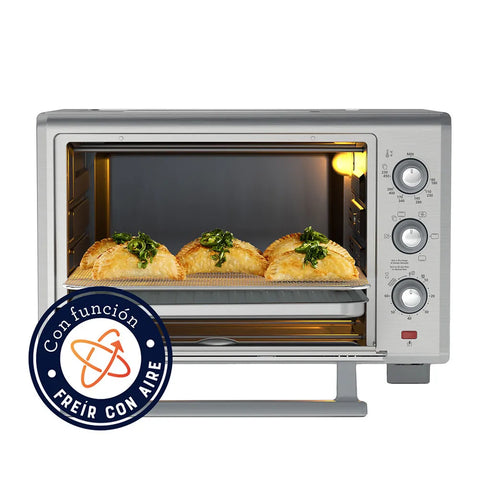 Horno con Freidora de Aire Oster® 35L, 5 funciones pre-programadas, control de temperatura hasta 230°C, recubrimiento antiadherente, y luz interior para fácil monitoreo.