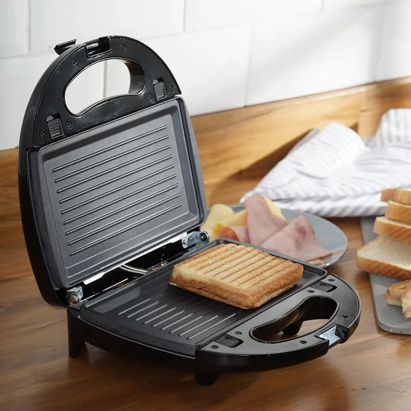 Sanduchera Universal Inox Multifuncional 3 en 1 con placas antiadherentes, cubierta de baquelita y acero inoxidable, e indicadores luminosos.